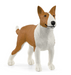Dog figurine with brown and white color pattern on a white background