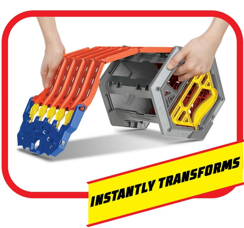 two hands roll out orange plastic track with yellow and blue at the foot of the track, from gray plastic carrying case frame. Caption reads "Instantly Transforms"