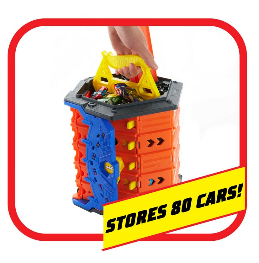 Orange with blue and yellow plastic Rollout Raceway in carrying case-storage mode. Hand holding yellow plastic handle, Hot Wheels cars fill carrying case. Caption reads: "Stores 80 Cars"