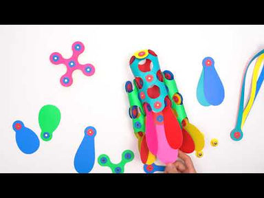 Clixo, a flexible, magnetic building kit for preschool children, kids, and tweens. Rainbow Clixo kit shown in its package, as pieces and then being built into several items with moving parts--a fish, a rocket,a helicopter, all shown being played with